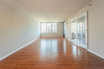 A long hallway with wood floors and white walls. at Lenox Club, Arlington, VA